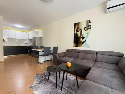 a living room with a couch and a table at Maryland Apartment incl Private Garage in Sofia