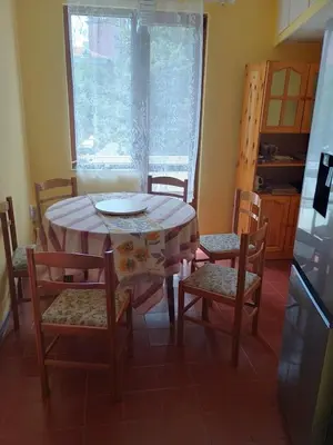 a dining room table and chairs with a plate on it at Apartment Lozenetz in Sofia
