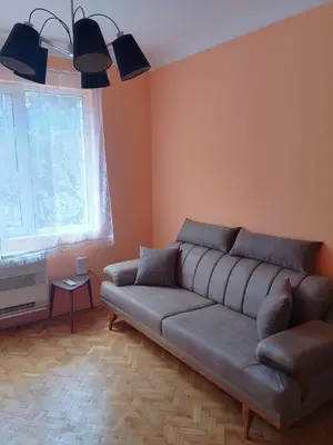 a living room with a couch and a window at Apartment Lozenetz in Sofia