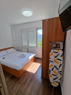 a small bedroom with a bed and a window at Apartment's Ortakchiev 2 in Sofia