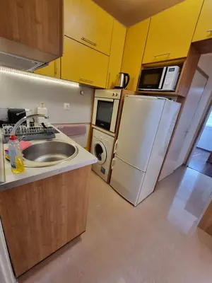 a small kitchen with a sink and a refrigerator at Apartment's Ortakchiev 2 in Sofia