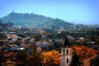 a city with a clock tower and a mountain at Comfortable 2BR Urban Getaway in City Center by Flat Mаnager in Plovdiv
