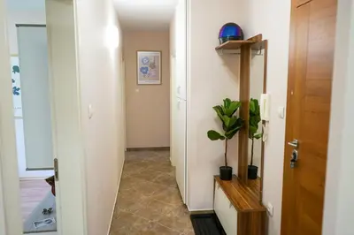 a hallway with a door and a potted plant at Comfortable 2BR Urban Getaway in City Center by Flat Mаnager in Plovdiv