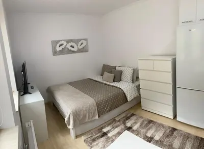 a small bedroom with a bed and a refrigerator at Ski-in Ski-out Studio, Grand Monastery, Pamporovo in Pamporovo