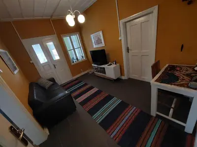 a living room with a couch and a television at Musala 1 Bed & Breakfast in Kyustendil