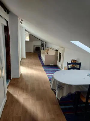 a living room with a white table and a couch at Musala 1 Bed & Breakfast in Kyustendil