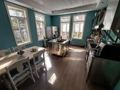 a kitchen with blue walls and a table and a stove at Musala 1 Bed & Breakfast in Kyustendil