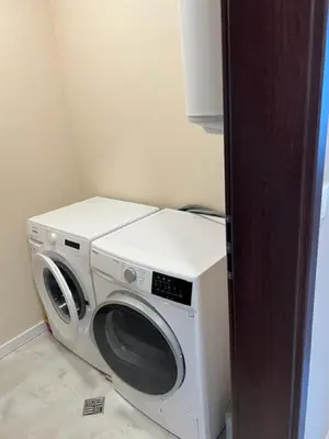a washer and dryer sitting in a room at Апартамент Комфорт, близо до Летището in Sofia