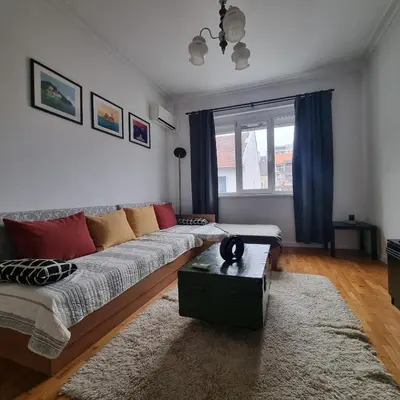 a living room with a couch and a table at Lovely 1 bdr apartment in Sofia city center in Sofia