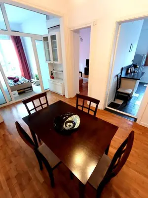 a dining table and chairs in a living room at Lovely 1 bdr apartment in Sofia city center in Sofia