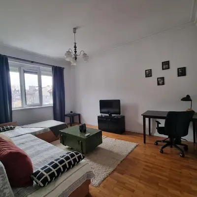a living room with a couch and a desk at Lovely 1 bdr apartment in Sofia city center in Sofia