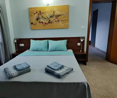 a bed with two pillows sitting on top of it at Shekerdejiiski guest house bansko in Bansko
