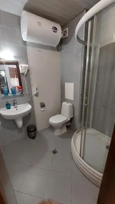 a bathroom with a toilet and a sink and a shower at Belvedere Holiday Club - Mountain View in Bansko