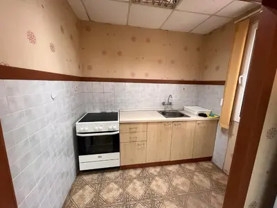a small kitchen with a stove and a sink at Почивна база Пиринпласт in Gotse Delchev