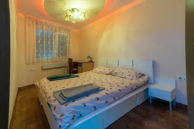 a bedroom with a bed with a white bedspread and a ceiling at Cozy Apart TOP Center AUBG Free Garage Parking in Blagoevgrad