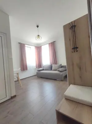 a living room with a couch and a table at Cozy Rooms Panagyurishte in Panagyurishte
