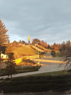 a park with a statue on top of a hill at Cozy Rooms Panagyurishte in Panagyurishte