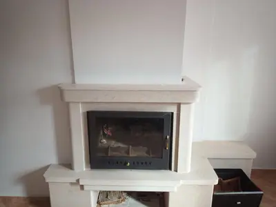 a stone fireplace in a living room at COZY ski-to-door apartment, Monastery 3 complex in Pamporovo