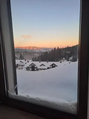 a view of a snow covered field from a window at COZY ski-to-door apartment, Monastery 3 complex in Pamporovo