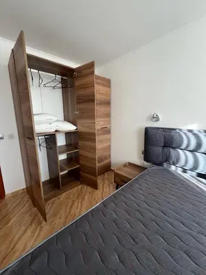 a bedroom with a bed and a desk and a sink at COZY ski-to-door apartment, Monastery 3 complex in Pamporovo