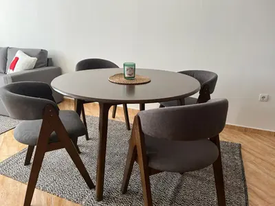 a table and chairs in a living room at COZY ski-to-door apartment, Monastery 3 complex in Pamporovo