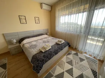 a bedroom with a bed and a window at Panorama view apartment in Sandanski