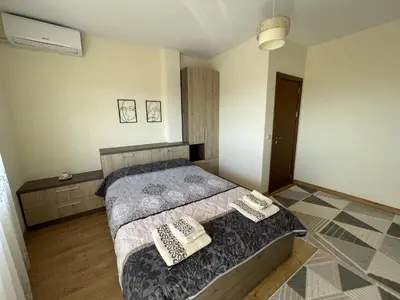 a bedroom with a bed with two pillows on it at Panorama view apartment in Sandanski