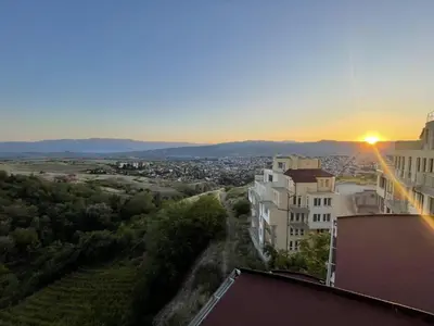 a view of a city at sunset from a building at Panorama view apartment in Sandanski