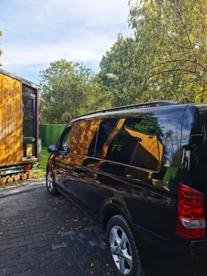 a black van parked on a street with a trailer at Sofia Town House, FREE PARKING in Sofia