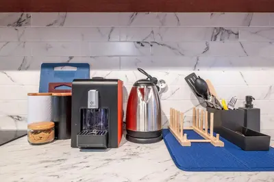 a kitchen counter with a coffee maker and utensils at Central Art-Inspired Flat with Private Garage in Sofia