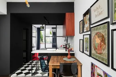 a kitchen with a table and some pictures on the wall at Central Art-Inspired Flat with Private Garage in Sofia