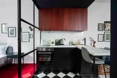 a kitchen with a stove and a table with chairs at Central Art-Inspired Flat with Private Garage in Sofia