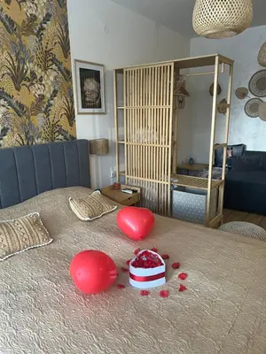 a table with two red hearts on a bed at Luxury Studio in Alpinе Lodge FREE SPA in Bansko
