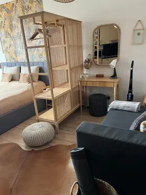 a bedroom with a bed and a desk and a mirror at Luxury Studio in Alpinе Lodge FREE SPA in Bansko