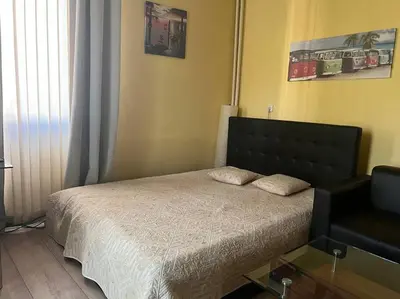 a bedroom with a bed with a black headboard at The Heart of Old Sofia (Shipka Street 24) in Sofia