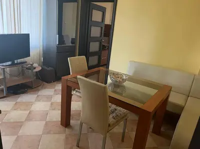a dining room with a table and chairs and a television at The Heart of Old Sofia (Shipka Street 24) in Sofia