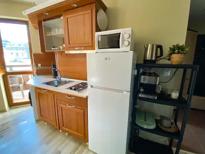 a kitchen with a white refrigerator and a microwave at DeLuxe Apartment 2OOm from Gondola in Bansko