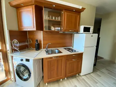 a kitchen with a sink and a washing machine at DeLuxe Apartment 2OOm from Gondola in Bansko