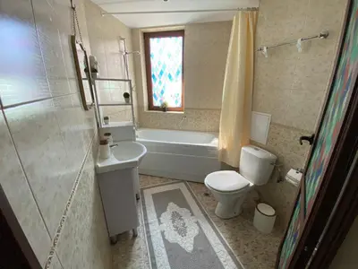a bathroom with a tub and a toilet and a sink at DeLuxe Apartment 2OOm from Gondola in Bansko