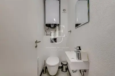 a small bathroom with a toilet and a sink at Madrid: A modern 2-bedroom apartment with parking in Sofia