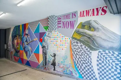 a mural on a wall with a hand holding a bottle at Geneva: A charming patio studio with private parking! in Sofia