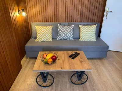 a coffee table with a bowl of fruit on a couch at Beauty downtown - TOP CENTER in Sofia