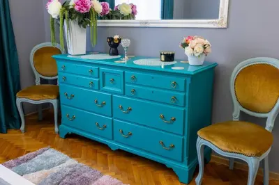 a blue dresser in a room with two chairs at Beauty downtown - TOP CENTER in Sofia