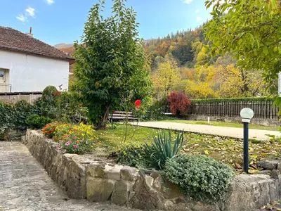 a garden with flowers and a fence and a house at Vila Omainiche Ribarica in Ribarica