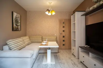 a living room with a couch and a table at Elegant spotless apartment in Sofia Center in Sofia