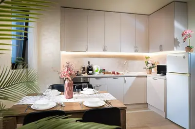a kitchen with a table and a white refrigerator at Free Parkingon Premises & Enjoy in Sofia