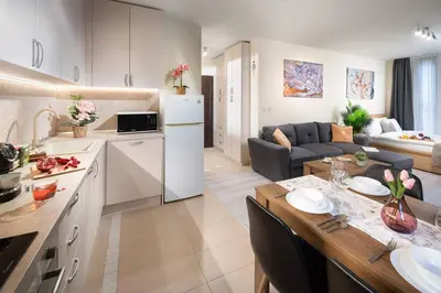 a kitchen and a living room with a table in a room at Free Parkingon Premises & Enjoy in Sofia