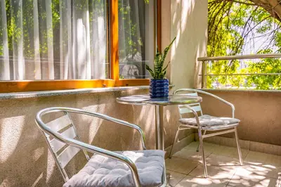a table and two chairs in front of a window at Super Center flat Parchevich in Plovdiv