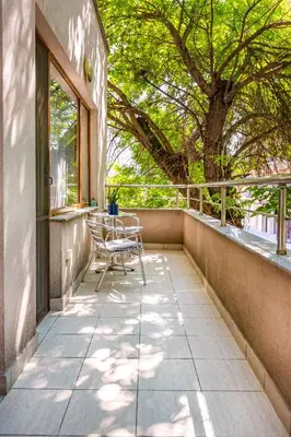 a patio with chairs and a table and a tree at Super Center flat Parchevich in Plovdiv