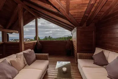 a living room with a couch and a table at Уютен апартамент с гледка в к-с Пирин Голф in Razlog